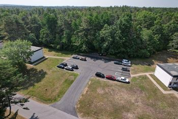 A parking lot with cars and a building in the background.
